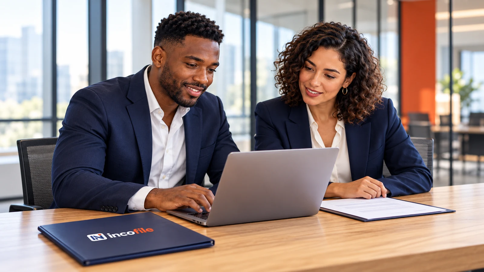 Two Incofile clients reviewing their LLC formation on a laptop